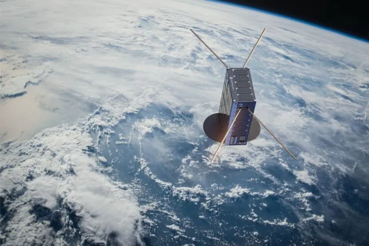 An Unseenlabs satellite orbiting Earth, equipped with antennas and solar panels, designed for RF signal detection. The satellite is positioned above a cloud-covered ocean, capturing data from space. © Unseenlabs