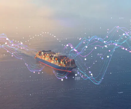 A cargo ship loaded with colorful shipping containers sails across the ocean, overlaid with futuristic data visualizations. The digital lines, graphs, and coordinates represent real-time tracking, analytics, and maritime intelligence, symbolizing the integration of advanced satellite technology in global shipping and logistics.
