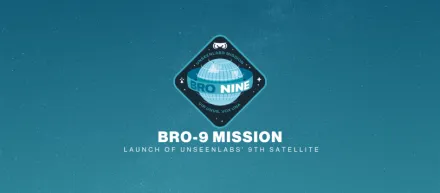 A mission patch for Unseenlabs' BRO-9 satellite, featuring a stylized globe design with the inscription "BRO NINE" in the center. The patch includes the Unseenlabs logo at the top and the Latin phrase "VIR UNUS, VOX UNA" at the bottom. The background is a starry blue sky with the text "BRO-9 MISSION – Launch of Unseenlabs' 9th Satellite."