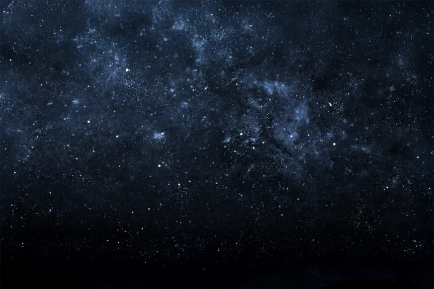 Star-filled deep space scene with a dense cluster of stars and cosmic dust, creating a dark blue galactic background.