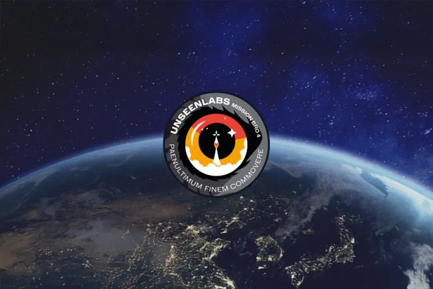 A view of Earth from space, showing a glowing horizon with city lights visible on the darkened landmasses. In the foreground, a circular mission patch for Unseenlabs' "Mission BRO-4" is prominently displayed. The patch features a stylized rocket launch within a black, red, and yellow design, surrounded by the Latin phrase "PAENULTIMUM FINEM COMMOVERE." The deep blue star-filled space serves as the backdrop.