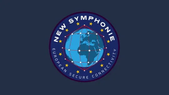 A circular mission patch for New Symphonie, a European secure connectivity initiative. The design features a stylized globe with interconnected red lines and white nodes, symbolizing a global satellite network. Surrounding the globe are twelve yellow stars, reminiscent of the European Union flag. The words "NEW SYMPHONIE" are displayed at the top, while "EUROPEAN SECURE CONNECTIVITY" is written along the bottom edge, emphasizing the project's focus on secure satellite communications. The patch is set against a dark blue background, reinforcing its European identity and technological significance.