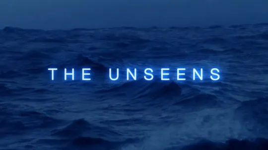 A dark, moody ocean scene with rolling waves under a deep blue sky. In the center, the words "THE UNSEENS" glow in neon blue, creating an eerie and mysterious atmosphere.