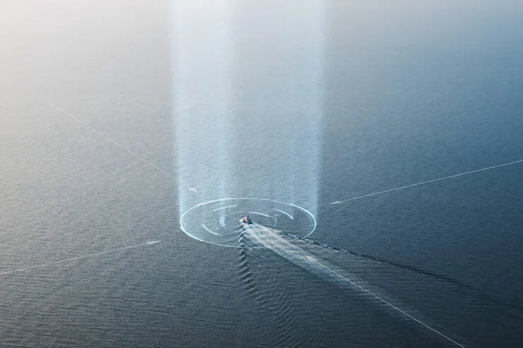 A digitally enhanced aerial view of a ship sailing through the ocean, emitting a vertical beam of light into the sky. The futuristic visualization represents advanced maritime tracking, surveillance, or signal detection, symbolizing next-generation technology in maritime monitoring.